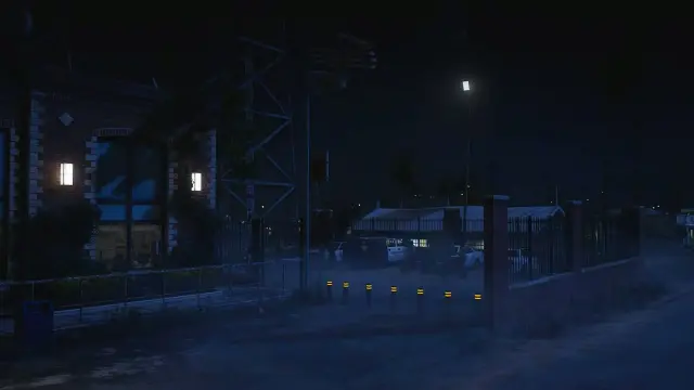 Fenced patrol parking yard of the sheriff station MLO at night under security lighting