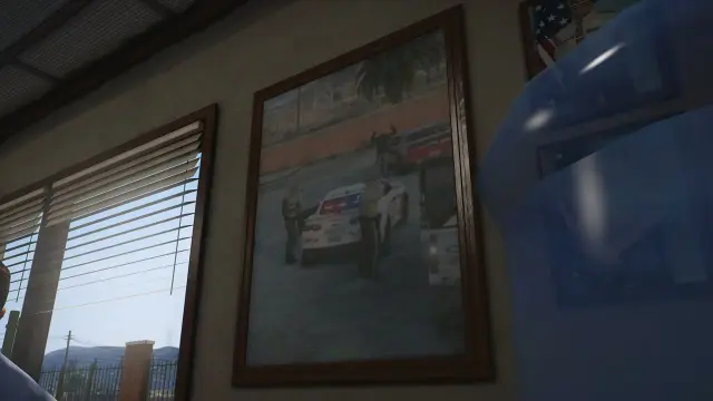 Framed department photos on the office wall inside the sheriff station interior